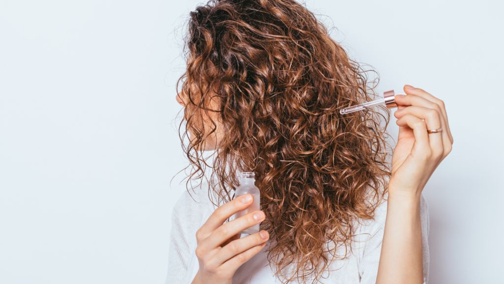 auburn curly hair with hair serum
